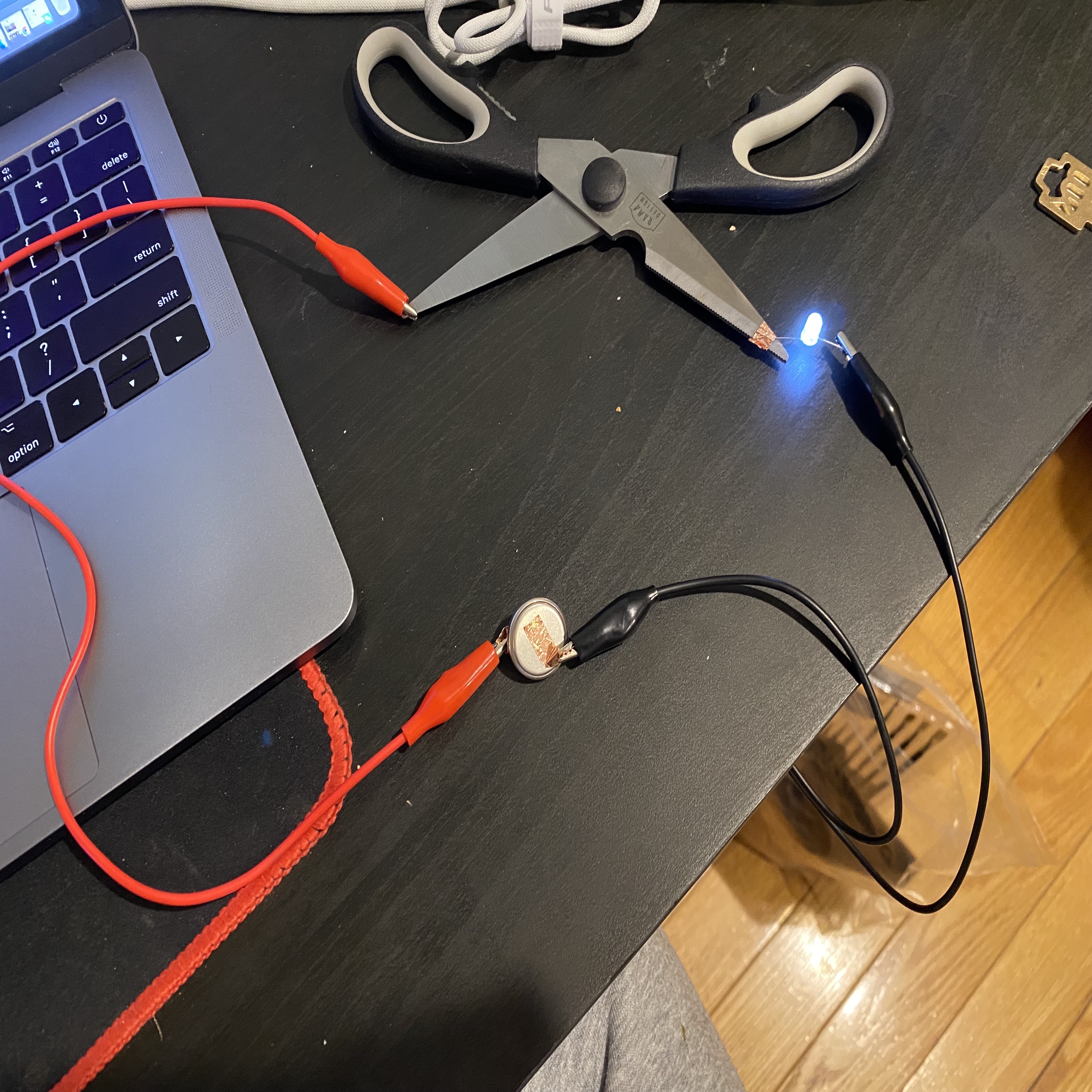 Try using scissors as a conductor to create a circuit